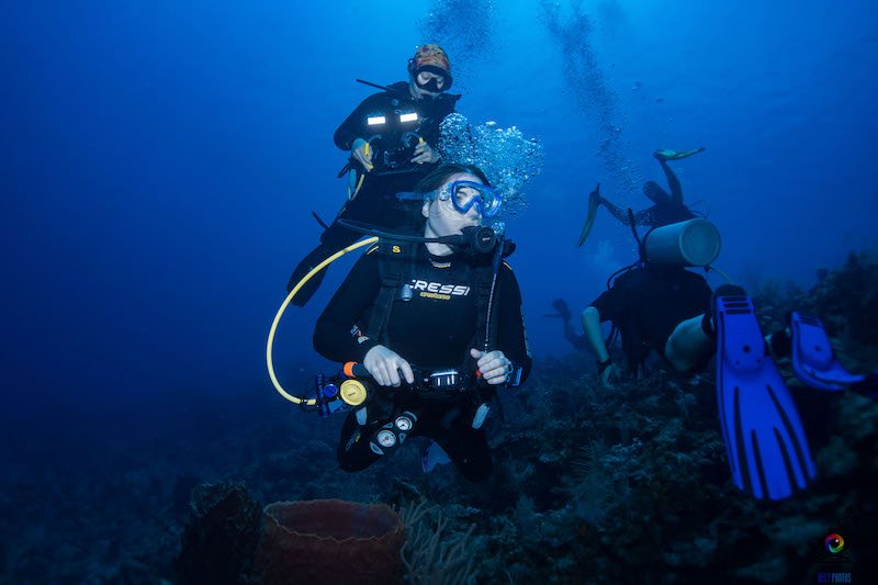 Allison Green looking away from camera underwater while scuba diving