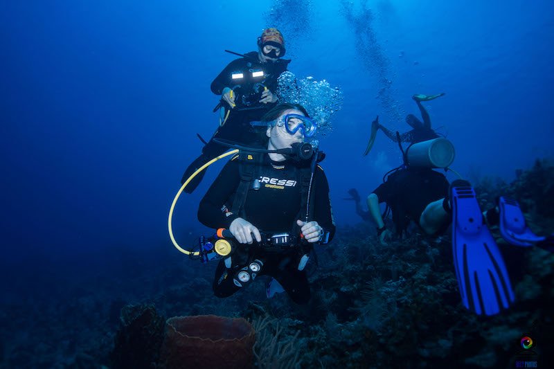 Allison Green in a cressi wetsuit diving underwater looking to the right