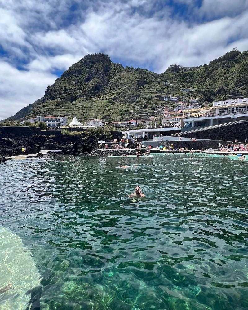 The waters of Porto Moniz, a popular swimming location in Madeira island with lots of people enjoying the waters