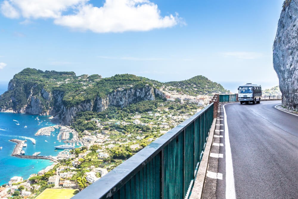 bus along the amalfi coast roads driving on the curvy mountainside road above the towns