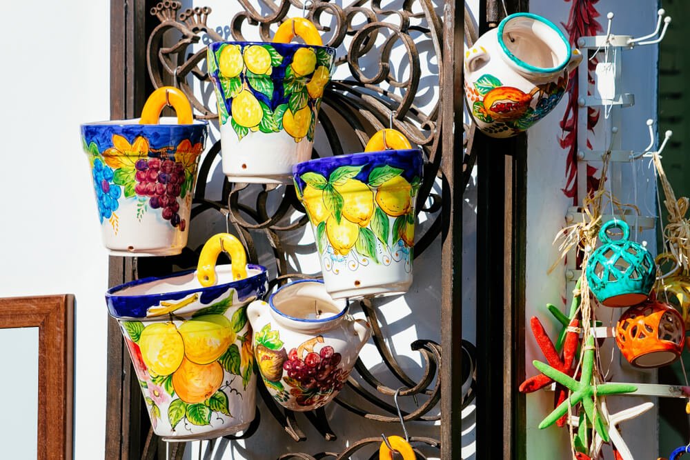 Colorful traditional ceramics vases and souvenirs at street market stores and shops in Positano town of Amalfi Coast in Italy