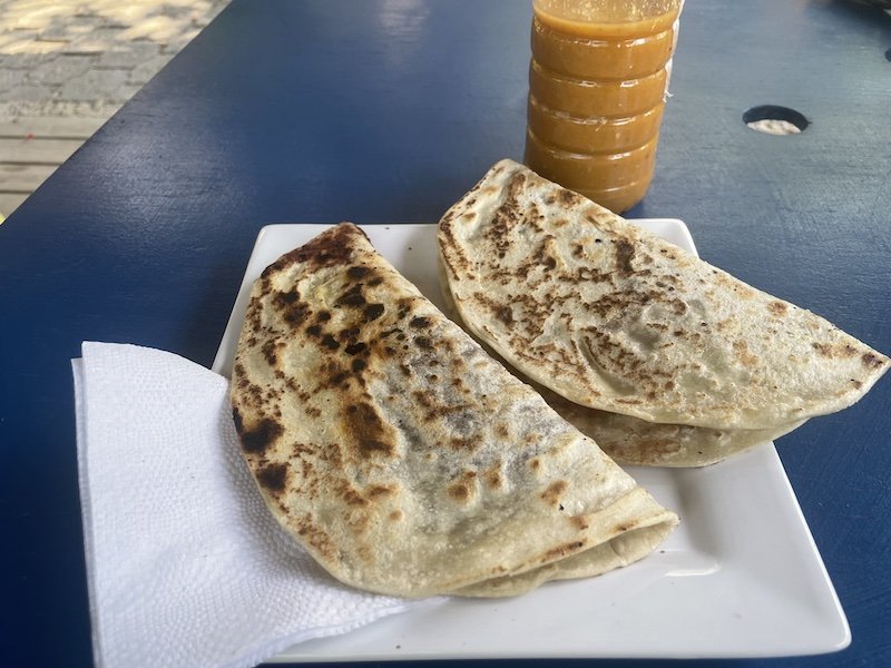 a homemade flour tortilla, the honduran baleada, filled with bean spread, cheese, and whatever filling you like