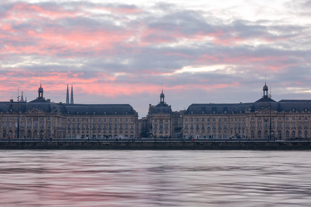 Landscape view of Place de la Bourse and the river Garonne at twilight before sunset in Bordeaux
