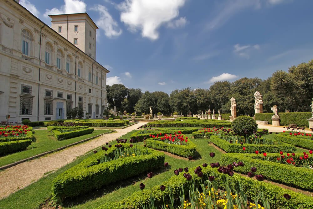 gardens and statues around villa borghese museum on a sunny day in rome