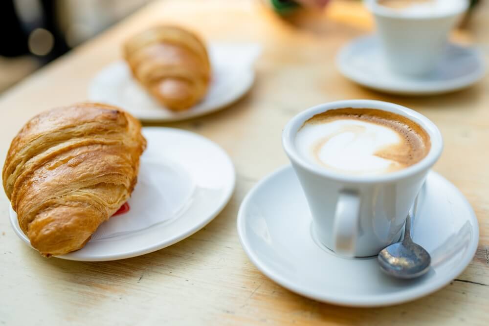 A typical italian breakfast of cappuccino and cornetto a sweet croissant like pastry