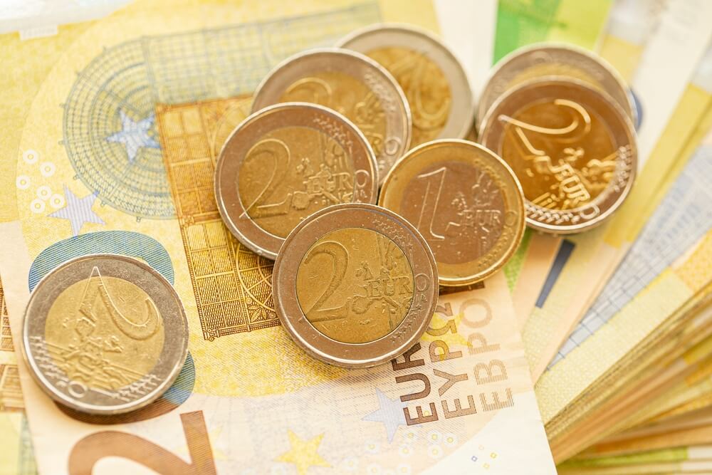 Euro money, bundle of euro banknotes fan and column of coins.