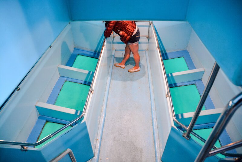 glass bottom boat with glass panels looking below into turquoise sea