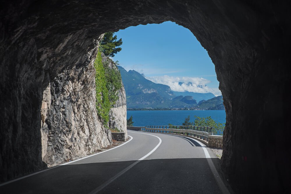 tunnel at gardesana road, lake of lake garda. view to garda lake while driving through a tunnel on a two-lane road