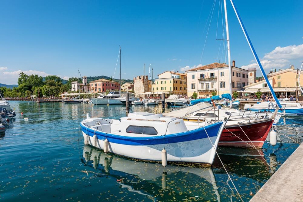 Port of the small village of Bardolino with many boats moored, tourist resort on the coast of Lake Garda (Lago di Garda)