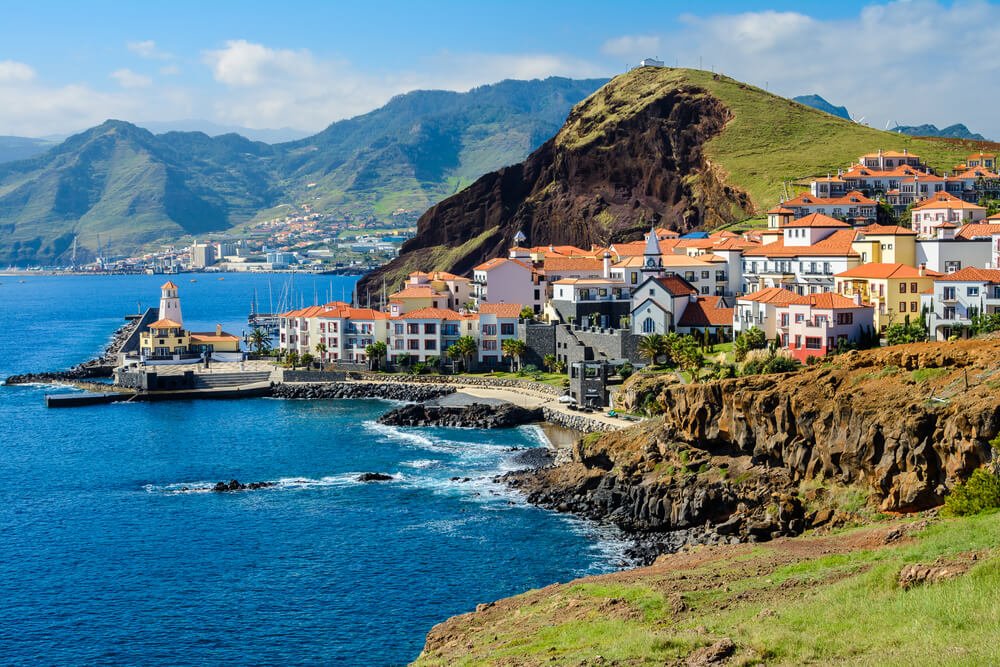 view of Marina da Quinta Grande in madeira with beautiful blue waters and rugged landscape