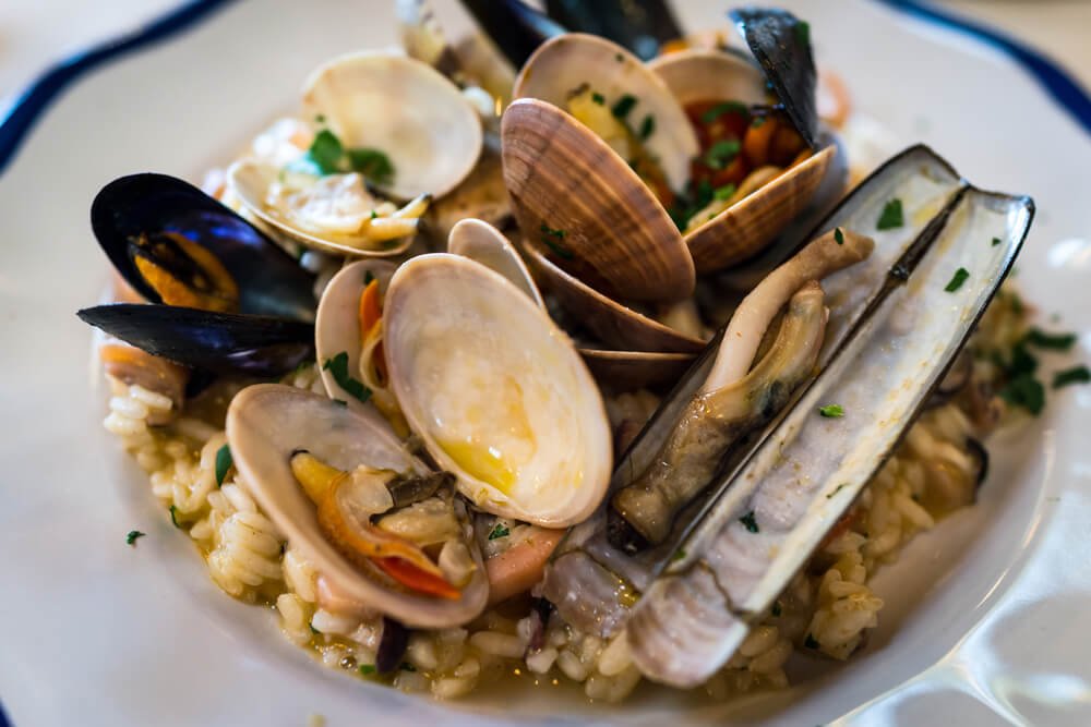 Italian delicious dish seafood risotto, rice with various of mussels in Positano, Italy