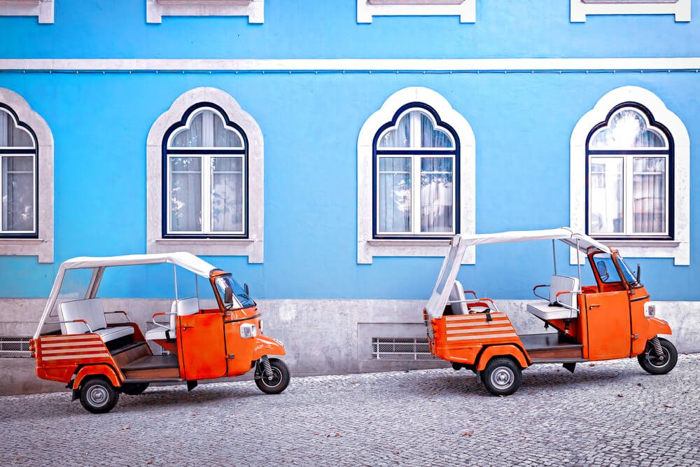 road with two little tuktuks on it while driving in portugal