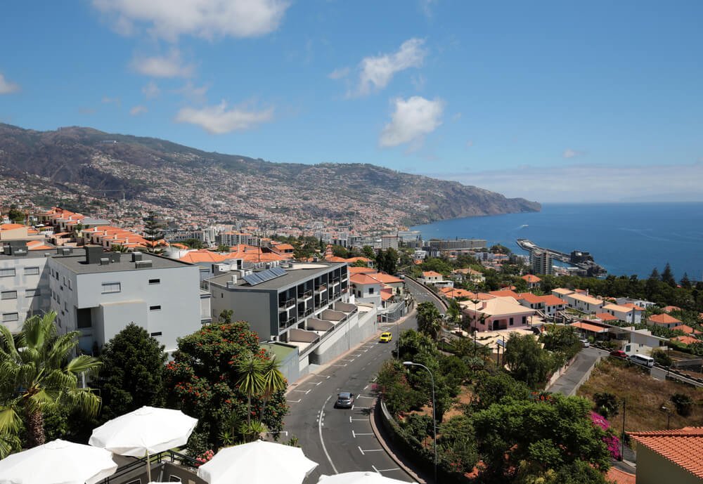 view of a road in madeira with a stunning view of the ocean in the distance