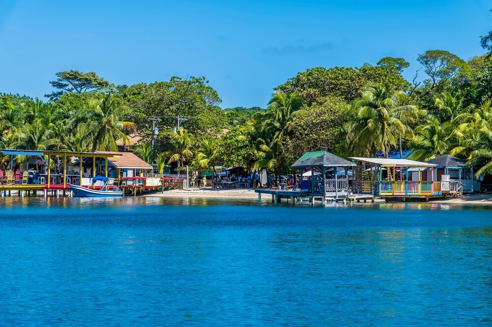 view of the town shoreline of roatan while on a catamaran