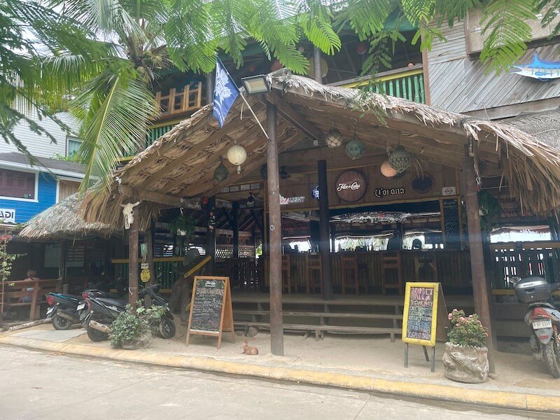 the sundowner beach bar in roatan in west end during the day time with thatch style