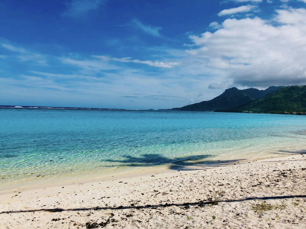 a beautiful crystal-clear beach at temae beach in moorea