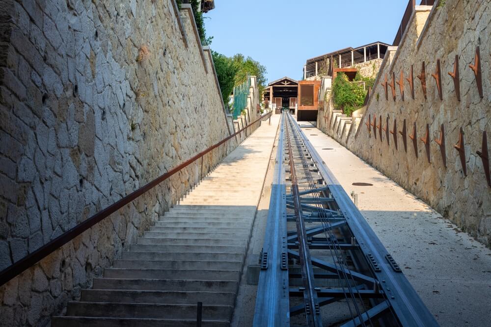 cable car in san pietro in verona with stone walls