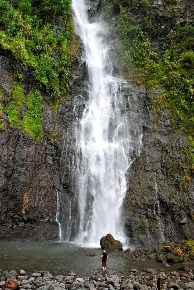 the waterfall in moorea with a person for scale