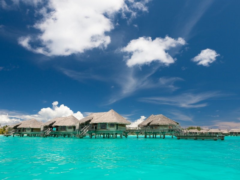 peaceful vibe of overwater bungalows in turquoise lagoon of bora bora