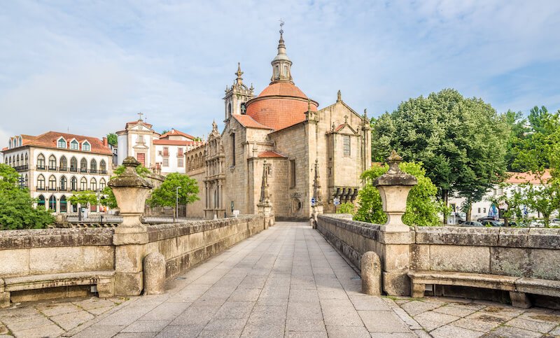 View at the Sao Goncalo monastery through the Old bridge over the river Tamega in Amarante ,Portugal