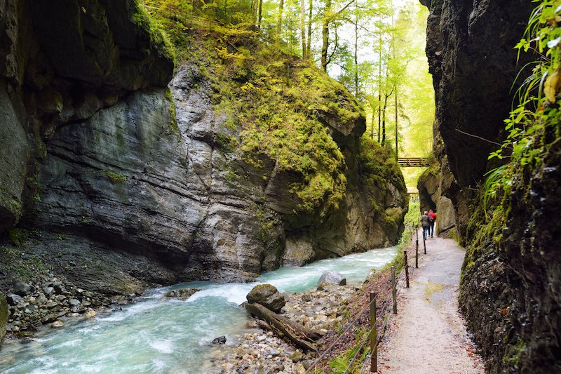 Blue water flowing in the Partnach Gorge or Partnachklamm, incised by a mountain stream in the Reintal valley near the south German town of Garmisch-Partenkirchen.