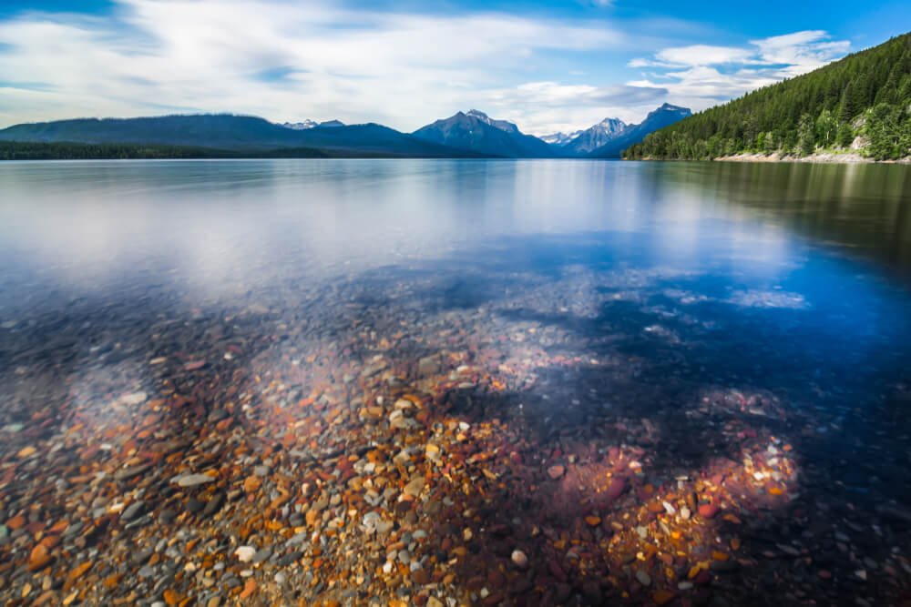 Lake McDonald Glacier National Park
with rainbow colored pebbles that are easily visible from the surface because the water is so clear in this lake