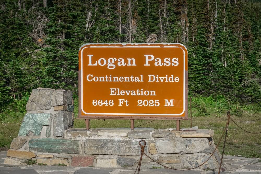 the sign at logan pass that also reads continental divide elevation 6646 feet