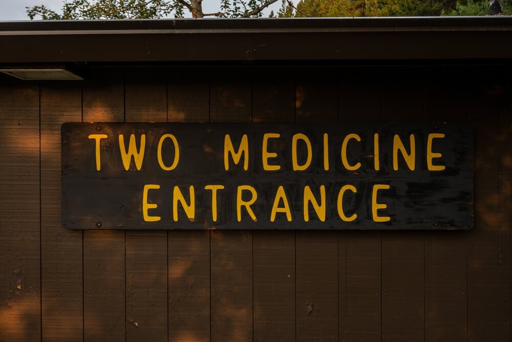 Two Medicine Entrance Sign On Side of Building in Glacier National Park
