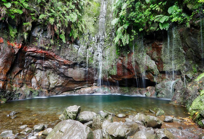 the 25 fontes waterfall in rabacal park in madeira with lush springs and pool
