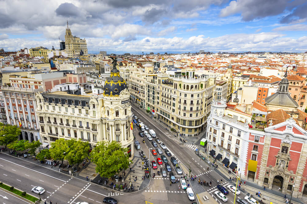 Madrid, Spain cityscape above Gran Via shopping street, with lots of cars and pedestrians in a busy intersection on one day in madrid