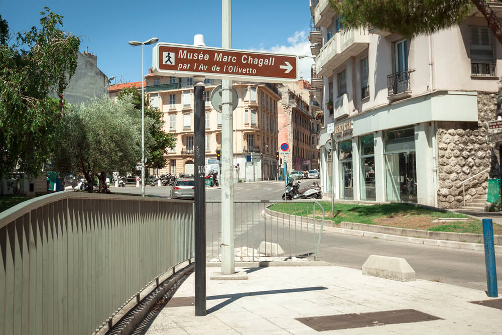 a sign leading to the famous. musee marc chagall a famous french painter