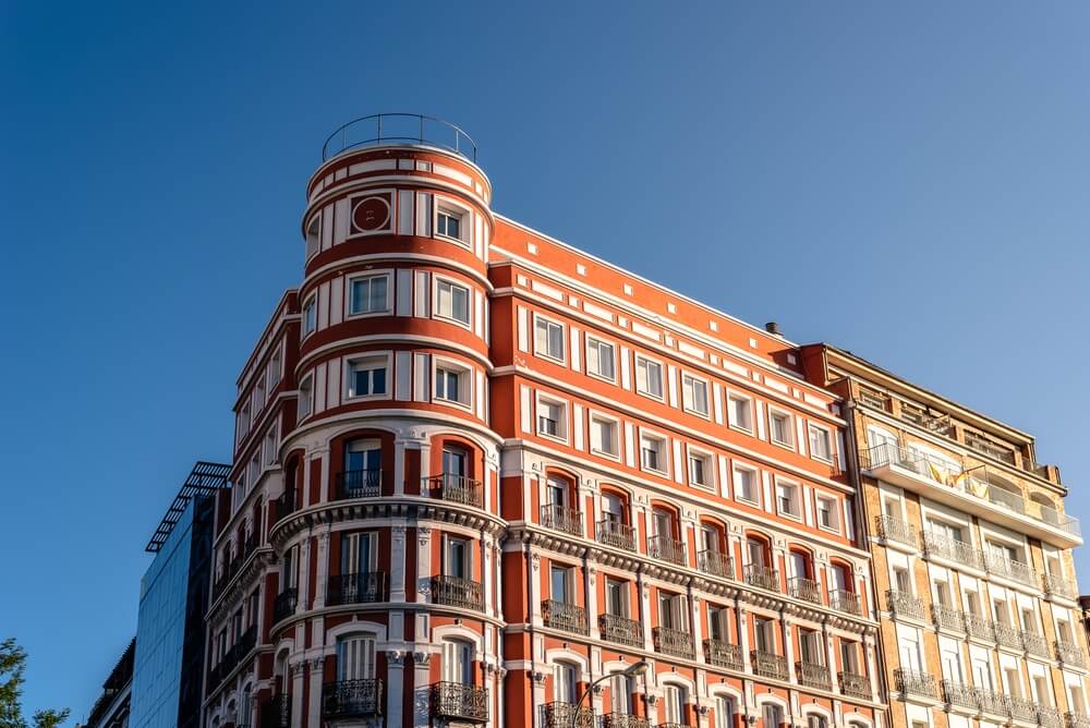 Old Luxury Residential Buildings In Madrid Salamanca district, with rounded red architecture on corner