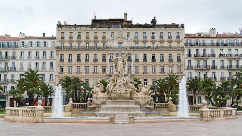 Place de la Liberté - fountain of Liberty square in Toulon on an overcast day with a statue in the middle of the fountain