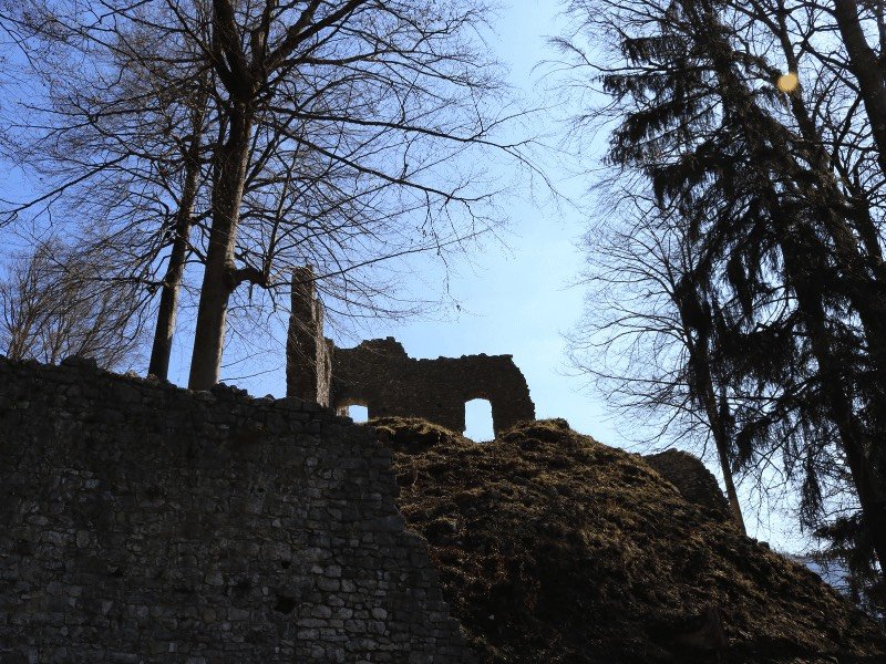 castle ruins in garmisch with trees all around it and stone ruins