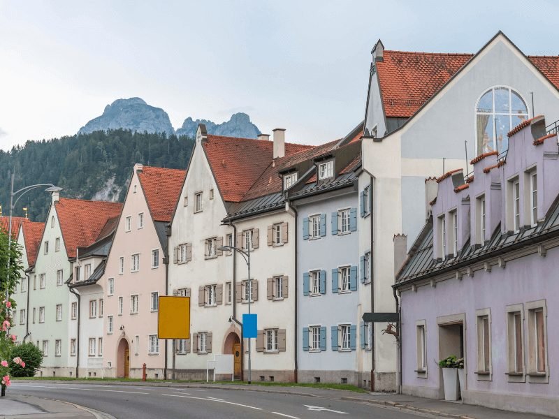 pastel colored buildings of fussen with an alpine background in bavaria germany