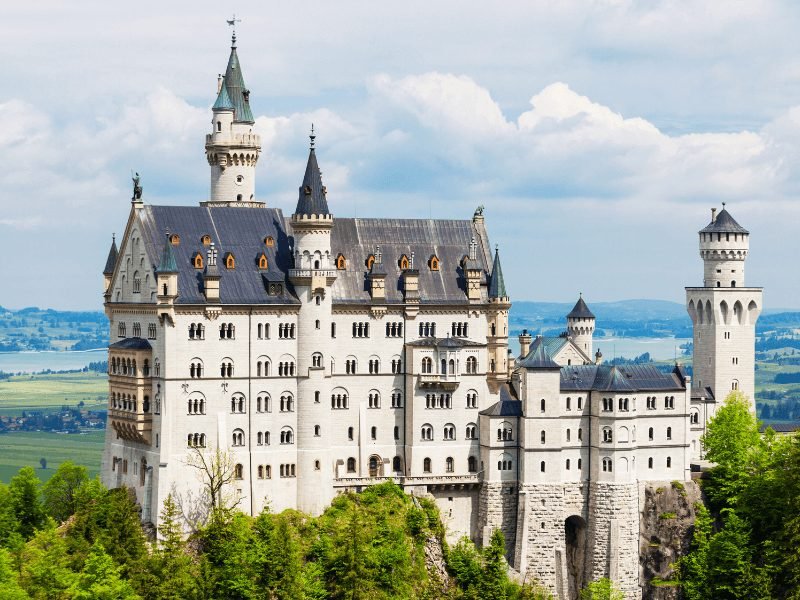 The famous fairytale-esque Neuschwanstein Castle, a many-story white castle with turrets, which inspired Walt Disney