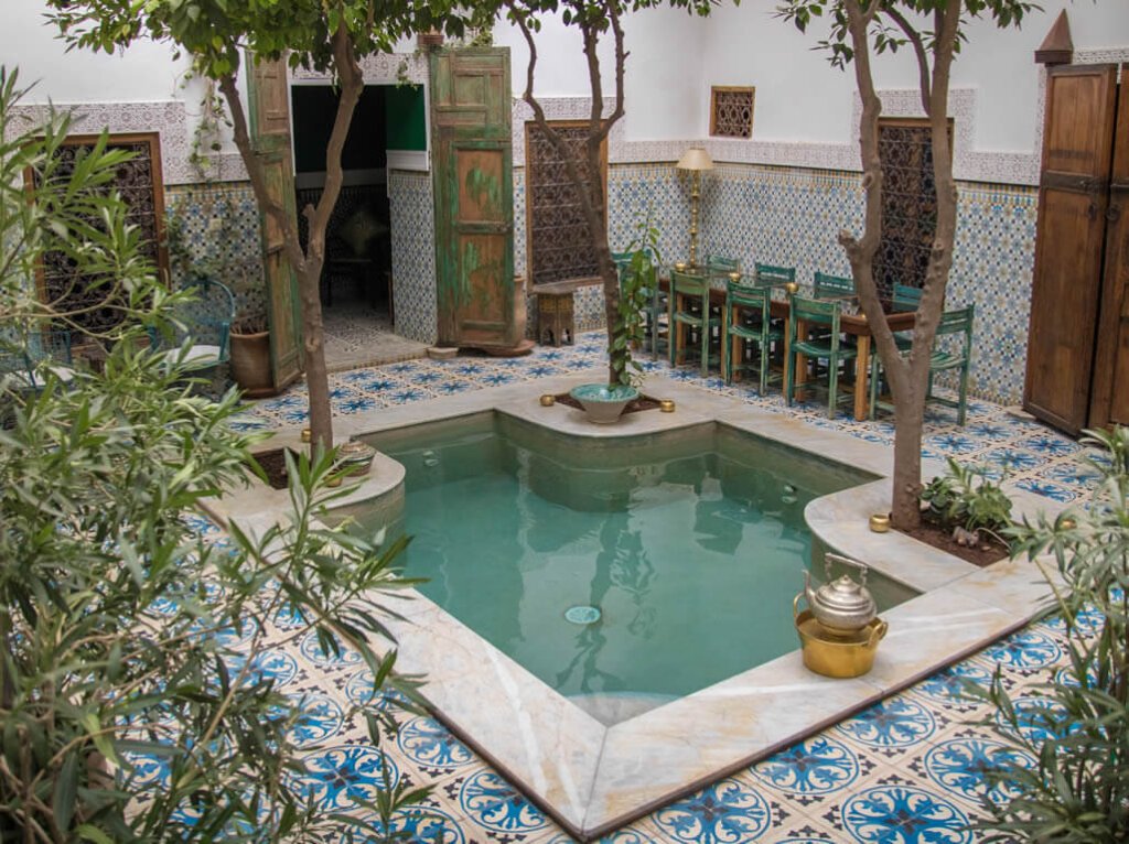 The beautiful hotel pool of Riad Yamina with tile around it