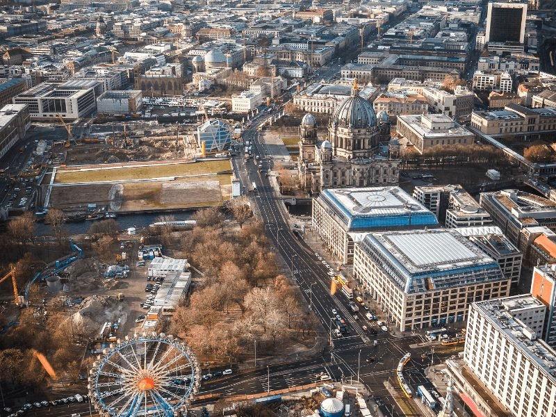 view over Berlin from the Fernsehturm TV tower with the berlin cathedral and ferris wheel visible in the frame