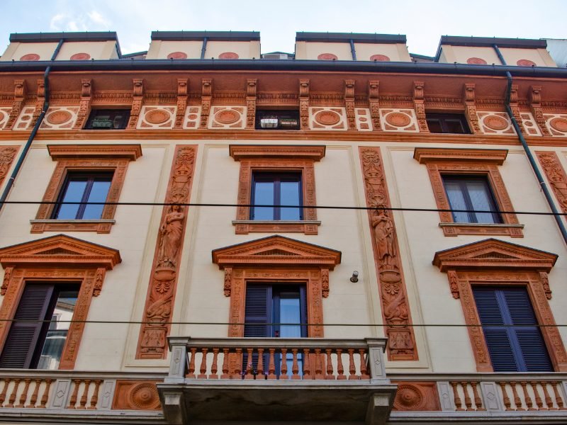 details of milan chinatown architeecture with red and pastel brown brick and stone