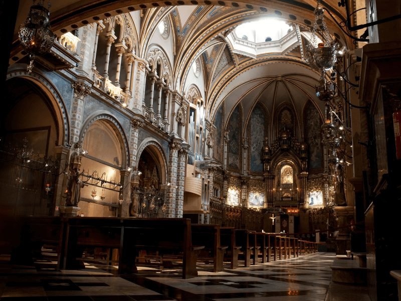 interior of the montserrat basilica with beautiful arches and lighting