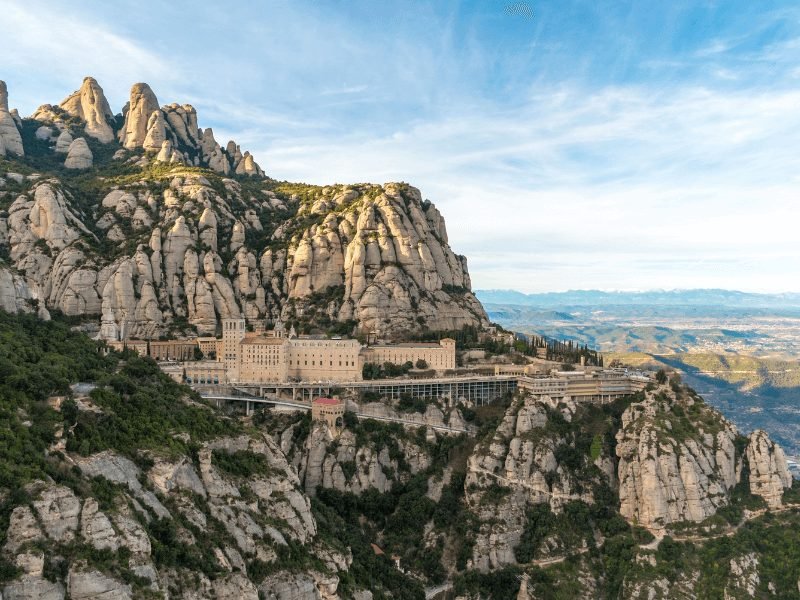 an aerial view of the montserrat monastery and countryside and the mountain