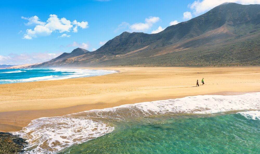 the beautiful cofete beach of fuerteventura with sand and two colors of water on a sunny day