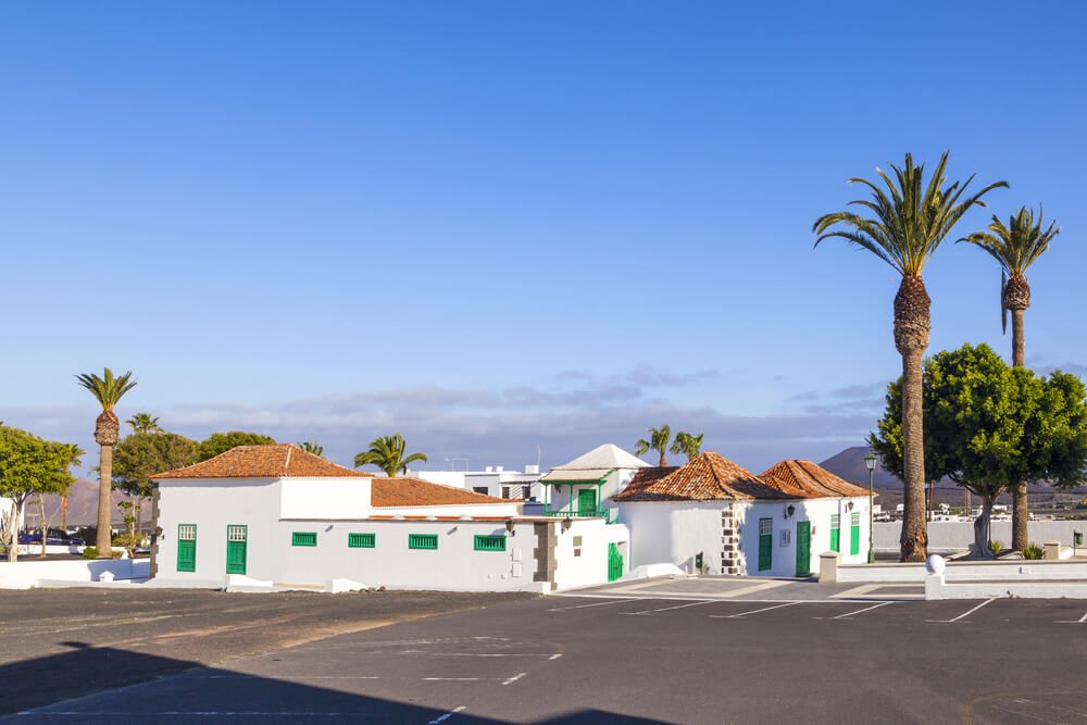 empty market place in Yaiza, Lanzarote, showing the parking places marked with white lines