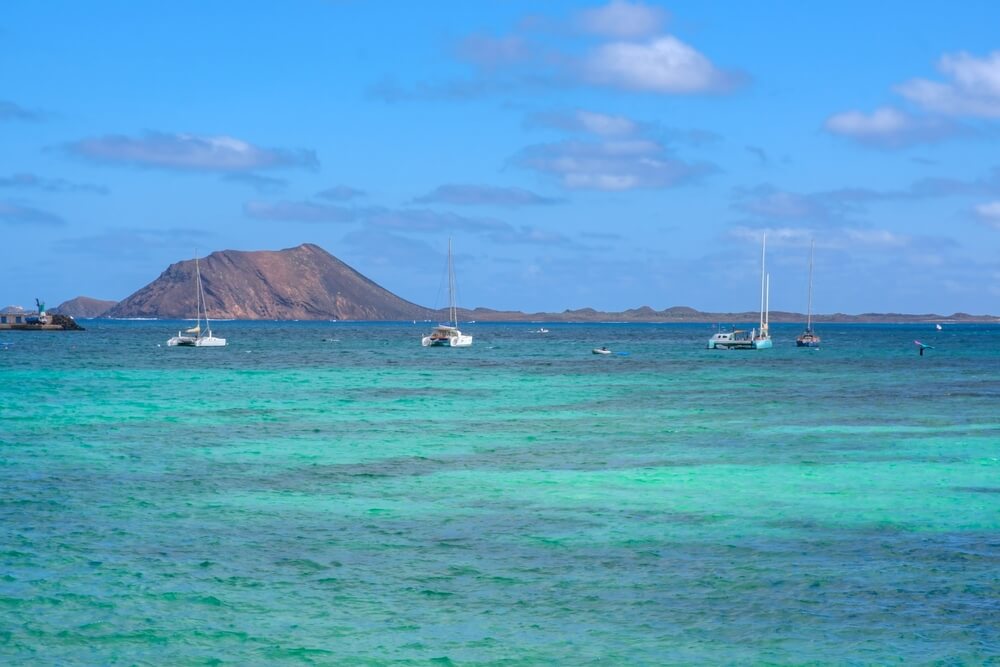 catamarans on their way to lobos island in the distance