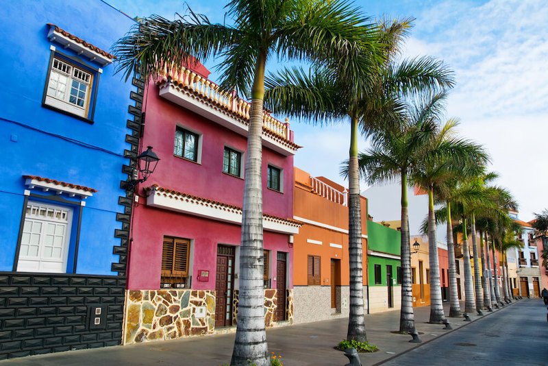 Tenerife. Colourful houses and palm trees on street in Puerto de la Cruz town, Tenerife, Canary Islands, Spain.
