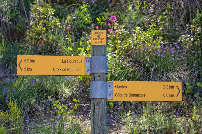 signs for different areas of the luberon in provence