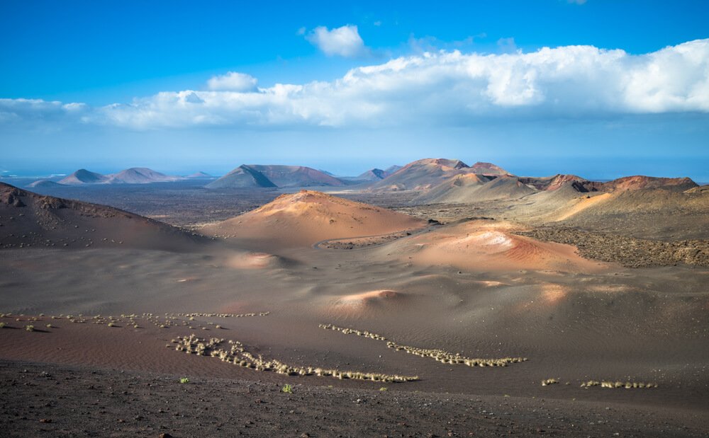 the landscape of timanfaya with volcanic soil and colors
