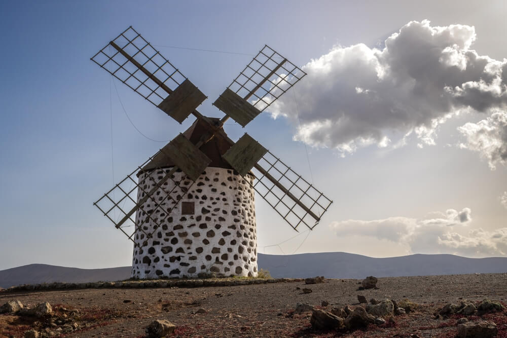 Historical well preserved round shaped windmills, built on a hill. Blue sky. Molinos de Villaverde, Fuerteventura, Canary Islands, Spain.
