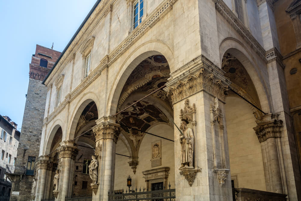 The elegant Loggia della Mercanzia, with arches that are decorated with ornate detail and high ceilings