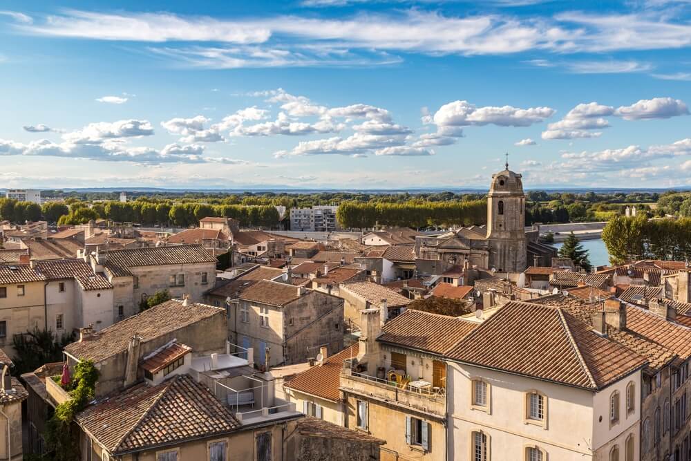 the rooftops of the city of arles with view of sky and buildings